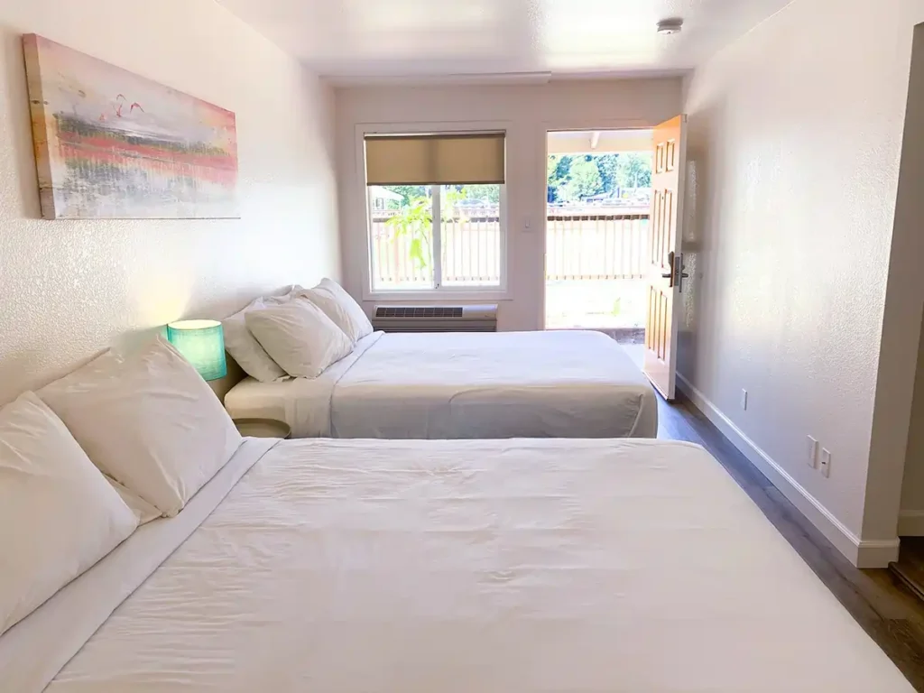 Two Queen Beds with outdoors in background